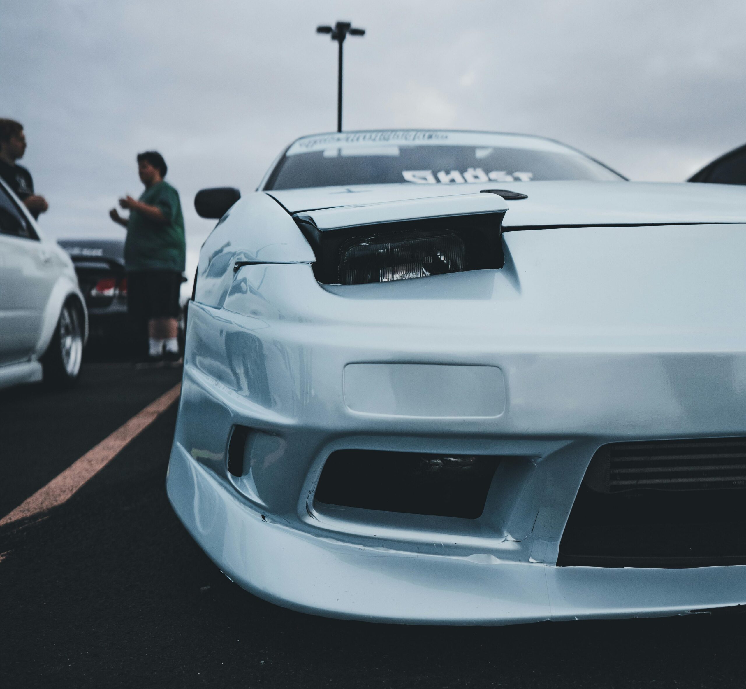 A white car with gaps that don't line up after a collision