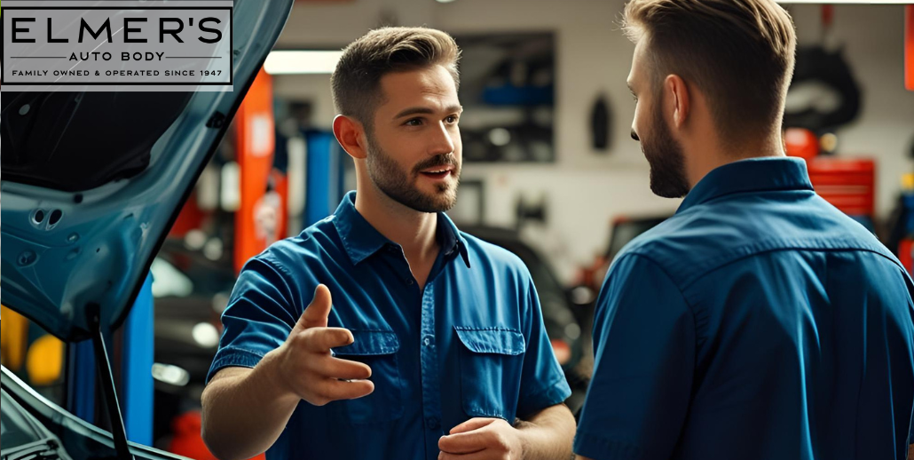 Communication is key. A mechanic speaks with a client during auto body repair.