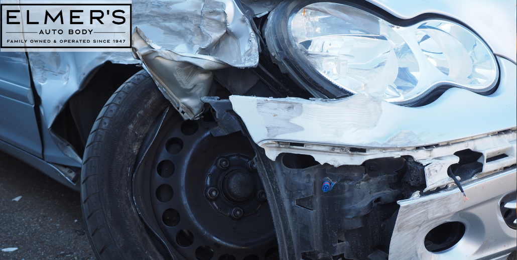 A damaged car awaits repairs. Will you choose a DRP shop or Elmer's Auto Body?