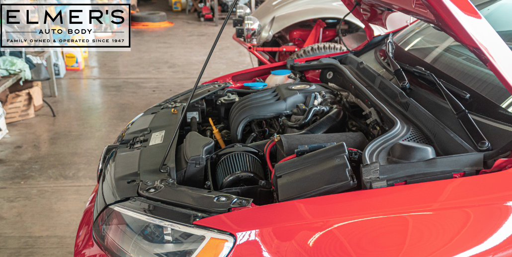 A red vehicle that has had frame repairs at an auto body repair shop