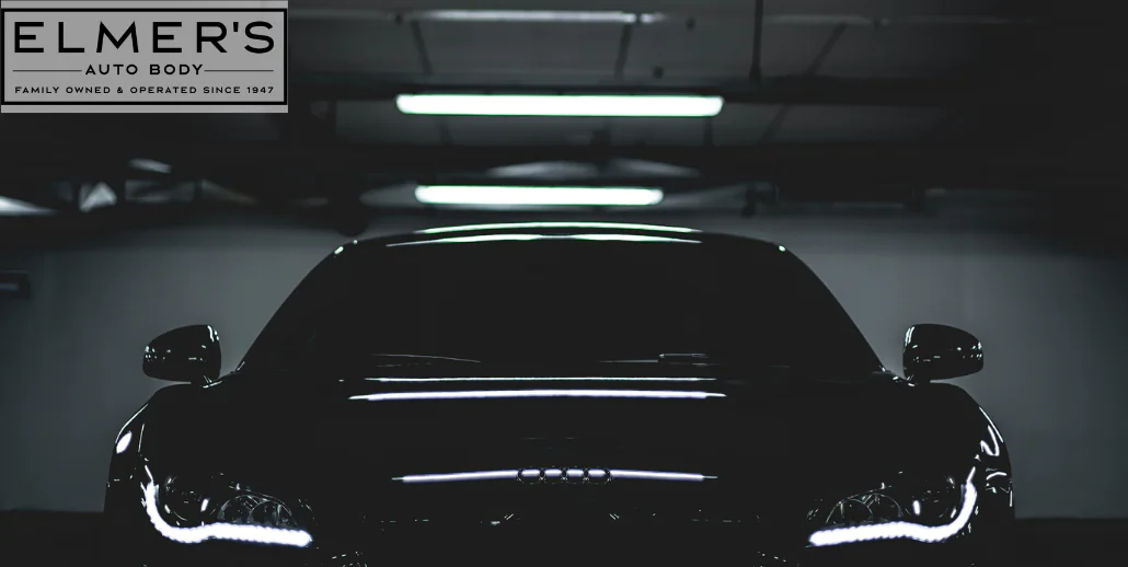 A dark car under bright lights. Even though it looks to be in pristine condition, bonded repairs can come apart in the summer if not properly cured.